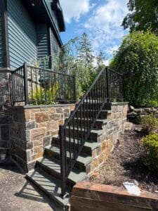 Custom black wrought iron stair railing installed at a New Jersey home